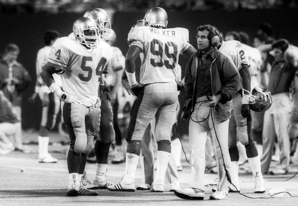 Jul 14, 1985; FILE PHOTO; Baltimore Stars linebacker Sam Mills (54) talks to assistant coach Vince Tobin (right) against the Oakland Invaders in the 1985 USFL Championship Game. The Stars defeated the Invaders 28-24 in what was the final game ever played by the USFL. Mandatory Credit: USA TODAY Sports
